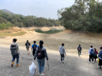 The Ninth Service Team members and some other College students working in pairs to clean up rubbish at Tai Lam Chung Reservoir, Tuen Mun on 6 January 2021